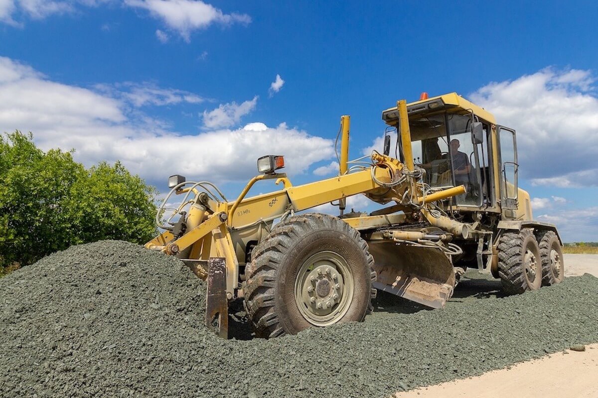 motor grader pushing earth equipment